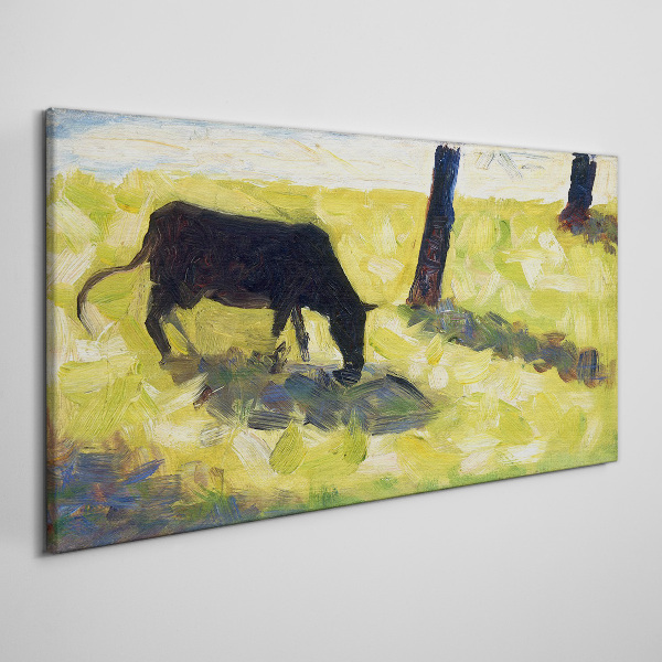 A cow grazing in a green landscape Canvas print