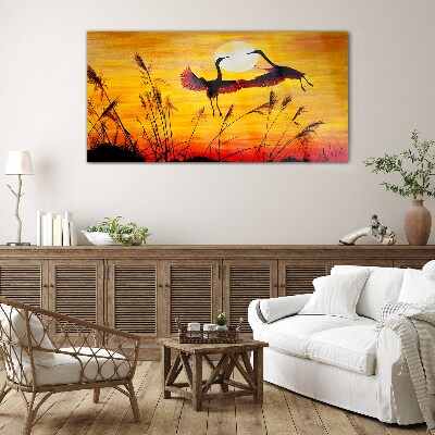 Dancing cranes at sunset Glass Wall Art