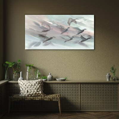 Flight of birds in a pastel aura Glass Wall Art