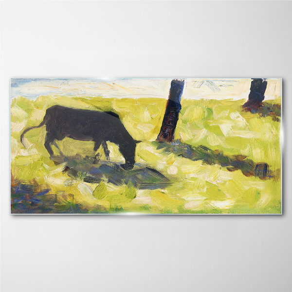 A cow grazing in a green landscape Glass Wall Art