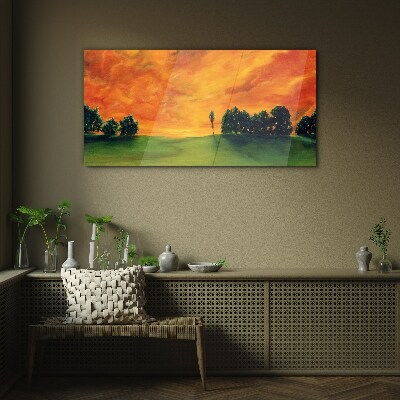 Sunset over the green hill Glass Print