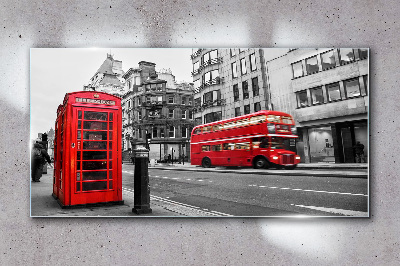 Red telephone in a grey city Glass Wall Art