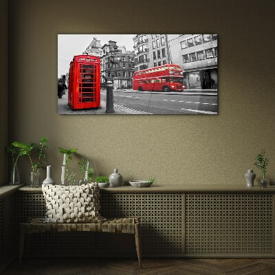 Red telephone in a grey city Glass Wall Art