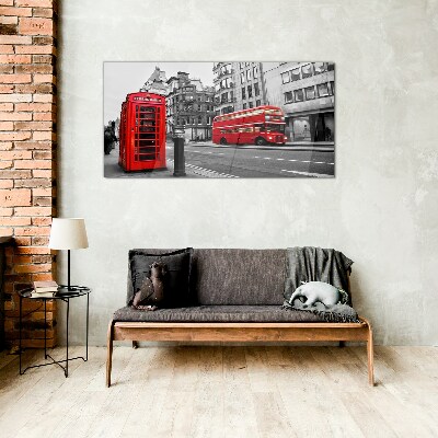 Red telephone in a grey city Glass Wall Art