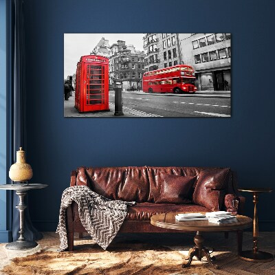 Red telephone in a grey city Glass Wall Art