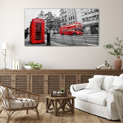 Red telephone in a grey city Glass Wall Art