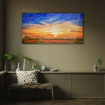 Sunset over a rural landscape Glass Print