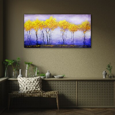 Golden trees in a purple landscape Glass Print
