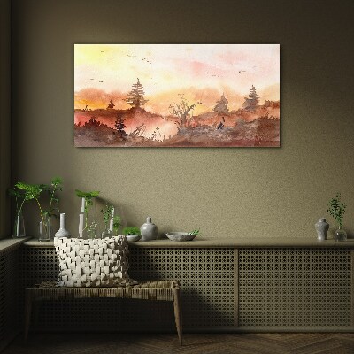 Sunset over a forest landscape Glass Print