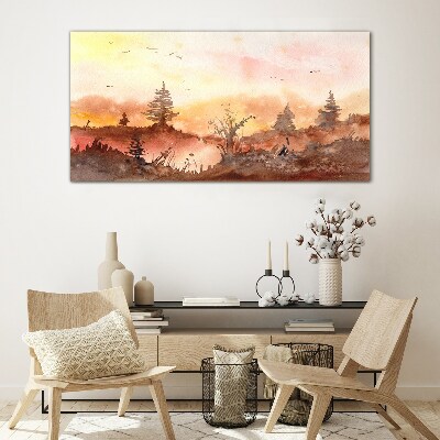 Sunset over a forest landscape Glass Print