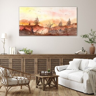 Sunset over a forest landscape Glass Print