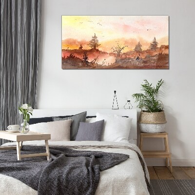 Sunset over a forest landscape Glass Print