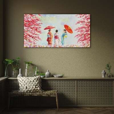 A spring walk under the blooming trees Glass Print
