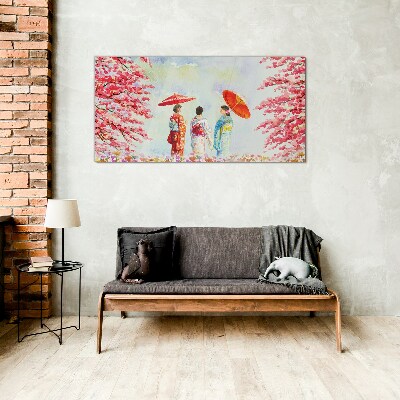 A spring walk under the blooming trees Glass Print