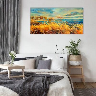 Golden grass over blue water Glass Print