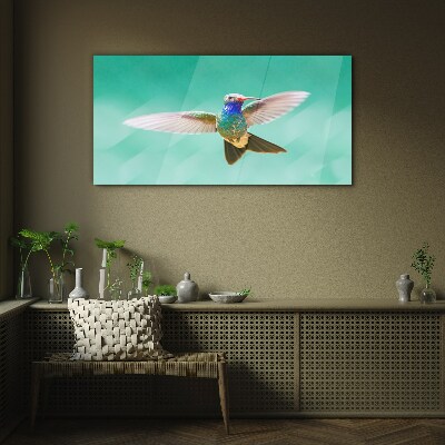 Hummingbird in blue background Glass Wall Art