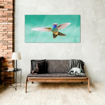 Hummingbird in blue background Glass Wall Art