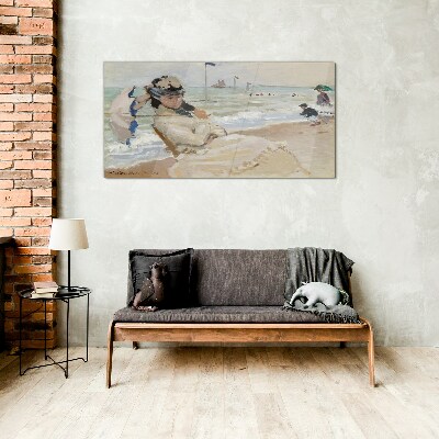 Woman on the beach with an umbrella Glass Print