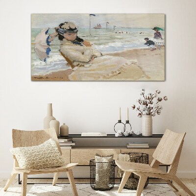 Woman on the beach with an umbrella Glass Print