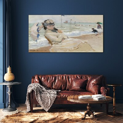 Woman on the beach with an umbrella Glass Print