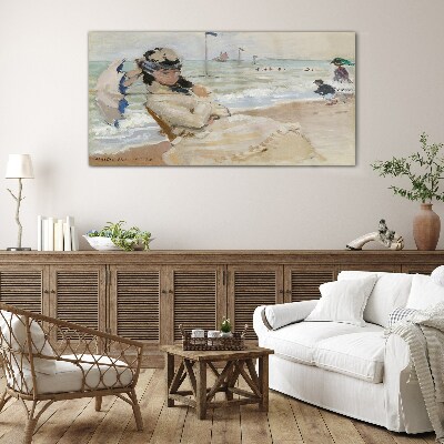 Woman on the beach with an umbrella Glass Print