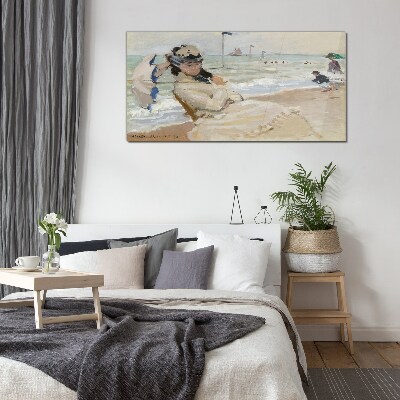 Woman on the beach with an umbrella Glass Print