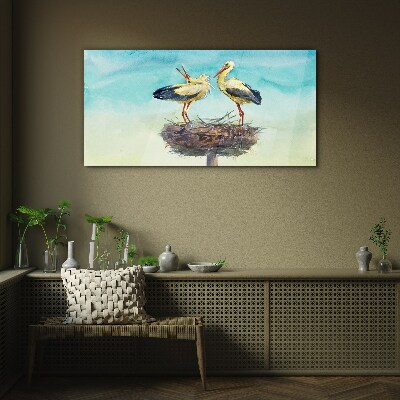 Storks on a nest in the blue Glass Wall Art