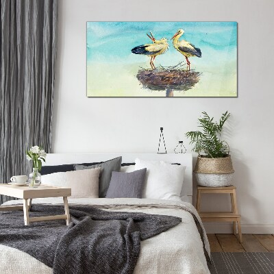 Storks on a nest in the blue Glass Wall Art