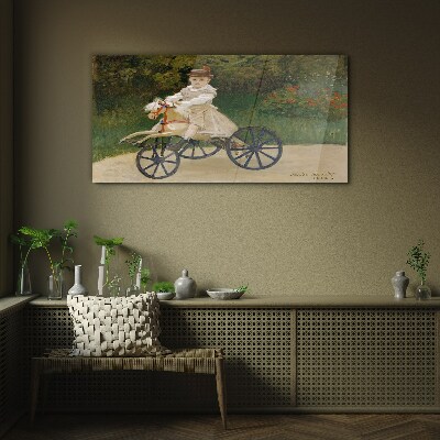 Child on a ride-on Glass Wall Art