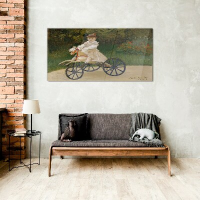 Child on a ride-on Glass Wall Art
