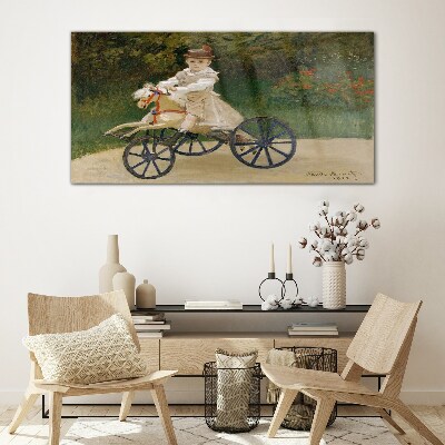 Child on a ride-on Glass Wall Art