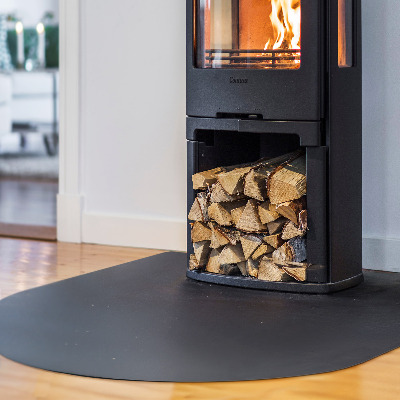 Fireplace pad in a semi-oval shape made from black steel sheet