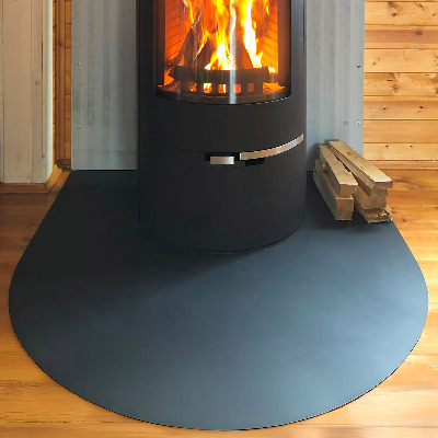 Fireplace pad in a semi-oval shape made from black steel sheet