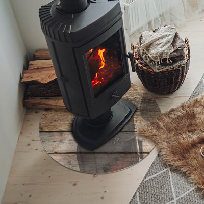 Glass hearth for stove round Wooden board in arrangement