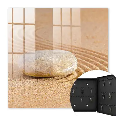 Wall mounted key box Stone on the sand, gentle waves