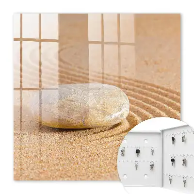 Wall mounted key box Stone on the sand, gentle waves