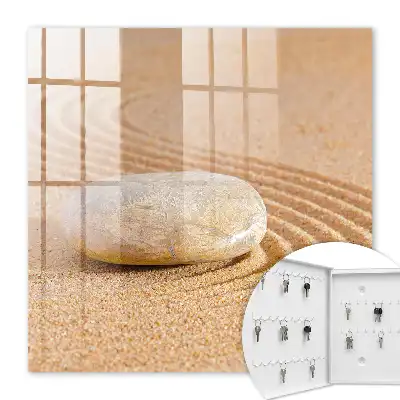 Wall mounted key box Stone on the sand, gentle waves