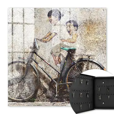 Key cabinet Children and a bicycle against an old wall