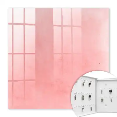 Wall mounted key cabinet Pink background with a subtle pattern
