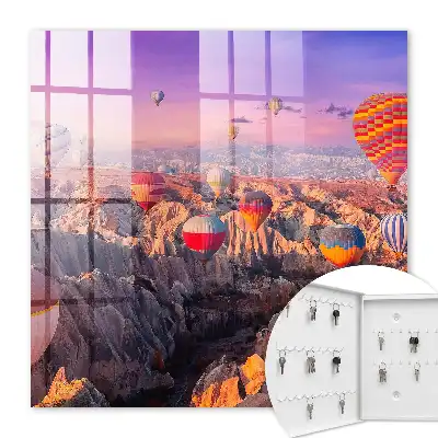 Wall mounted key cabinet Balloons in the air over a rocky valley