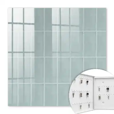 Wall mounted key cabinet Blue tiles in muted tones