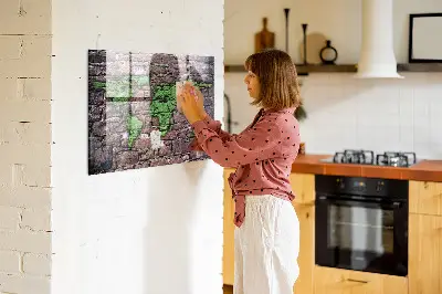 Magnetic glass dry erase board featuring a brick world map design